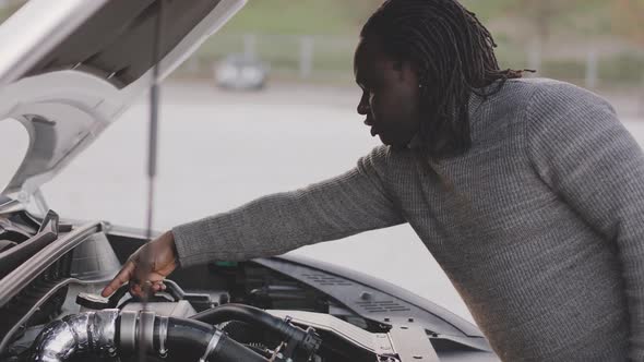 African American Black Man Trying To Repair Broken Car Engine on the Road alt