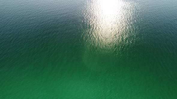 Aerial Panoramic View of Seascape with Crystal Clear Azure Sea and Rocky Shores alt
