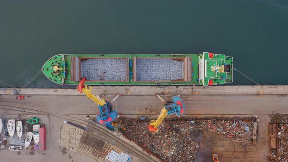 Drone View Vertically Down to the Cargo Crane Loading the Dry Cargo Ship alt