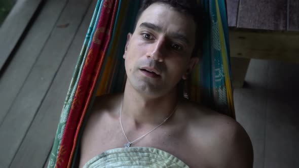 Man in Hammock Laying Alone Abandoned and Getting Mad Distracted, Loneliness Mentally Ill