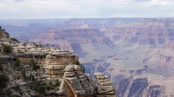 Tourists on Cliff at Grand Canyon alt