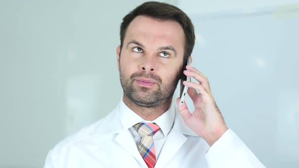 Doctor Talking on Phone in Hospital Redhead alt