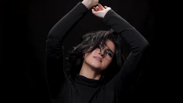 Woman with Curly Hair and Dark Makeup Dancing