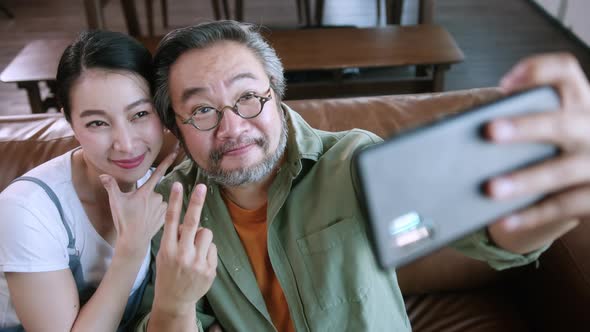 happiness joyful family love concept Asian family holiday activity dad holding smartphone alt