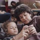 Woman and Son with Smartphone in Flee Camp - VideoHive Item for Sale