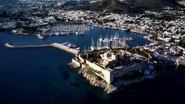 View from drone on full of yachts Bodrum harbour and ancient Kalesi castle in Mugla in Turkey alt