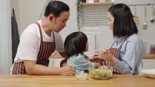 Asian boy who dislikes vegetables, is being asked by his parents to eat vegetables for his health.