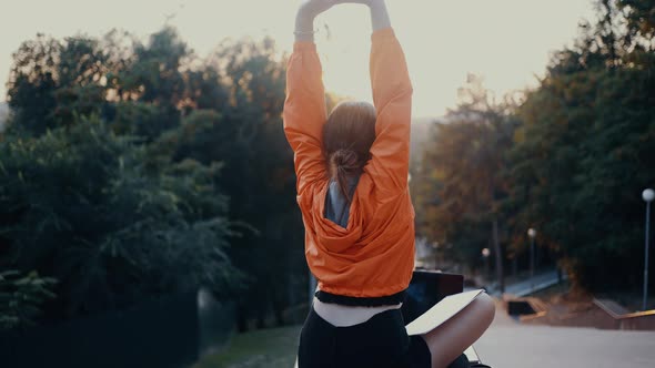The Tired Young Student Takes a Break From Classes Raises Her Hands Stretches Then Turns to Face the alt