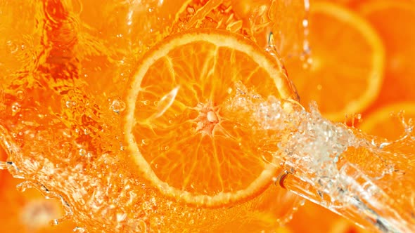 Super Slow Motion Shot of Splashing Water From Rotating Tangerine Slice at 1000Fps. alt
