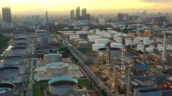 4k aerial view drone of refinery oil petroleum production factory with river reflecting surface sunr alt