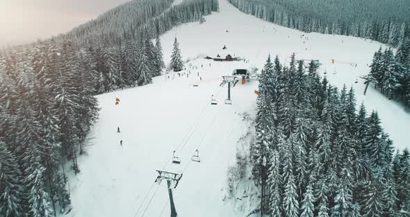 People Tourists Ski on Snowy Mountain Peak Slope on Winter Holidays in Ukraine