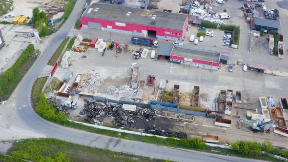 Junkyard unit with a transporter relocating rubbish.  alt