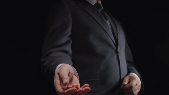 Businessman throws up several red playing cubes