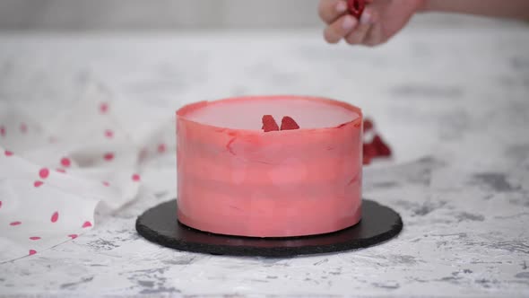 Woman Hands Placing a Raspberries Onto Freshly Cooked Cake