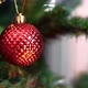 Red Christmas ball on a branch of a New Year tree on Christmas Eve. - VideoHive Item for Sale