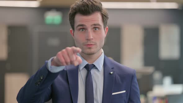 Portrait of Businessman Pointing at the Camera alt