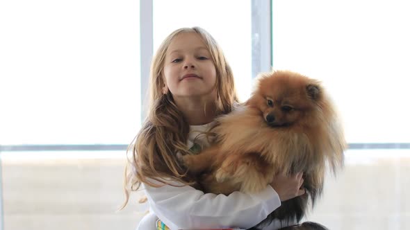 Young Teen Girl Hugging Pomeranian Dog with Love