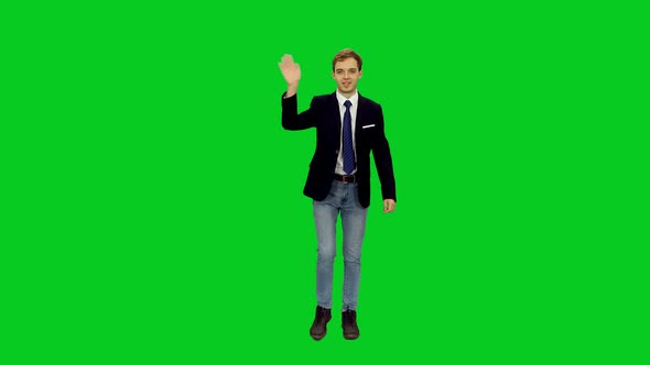 Young Handsome University Student Waving Hand Hello while Walking on Green Screen