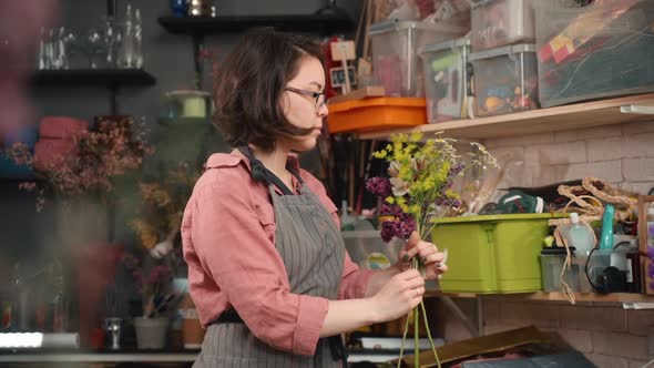 Female Arranging Flowers Asian Girl Florist Thinking About Bouquet Design. Concept Entrepreneur