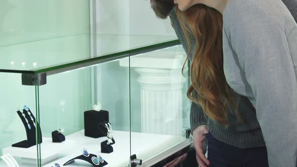 Close Up of a Happy Couple Shopping Jewelry Together alt