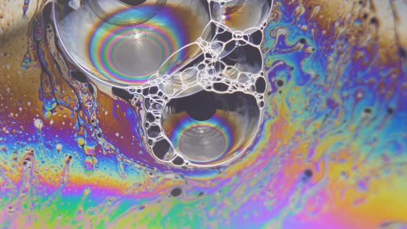Abstract Liquid Light Forms Colorful Fluid Flow Around Big Bubbles alt