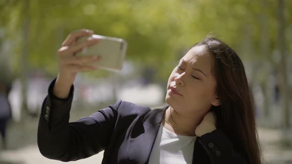 Attractive Girl Taking Selfie with Smartphone alt