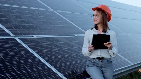Inspector Engineer Woman Holding Digital Tablet Working in Solar Panels Power Farm alt