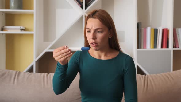 Woman with Negative Pregnancy Test. Sad Woman with Emotions at Home alt