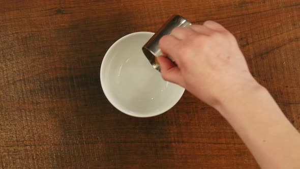 Barista Pours Caramel Syrup in a Cup alt