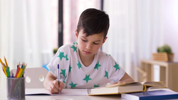 Boy Writing To Notebook at Home 26 alt