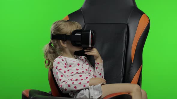 Child Girl Using VR Helmet To Play Simulation Game App. Watch Virtual Reality 3d Video. Chroma Key alt