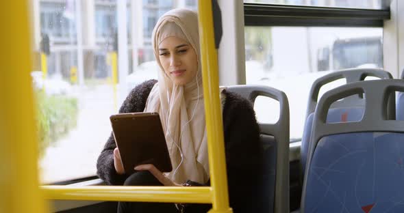 Woman in hijab using digital tablet 4k alt