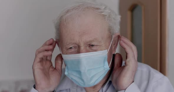 Portrait of Grandfather Wearing Medical Mask and Looking Confidently at Camera alt