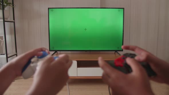 Close Up Children's Hands Holding Joystick Game Play Video Game On Green Screen Tv alt