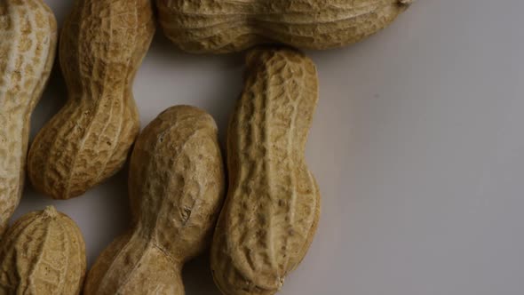 Cinematic, rotating shot of peanuts on a white surface - PEANUTS 005 alt