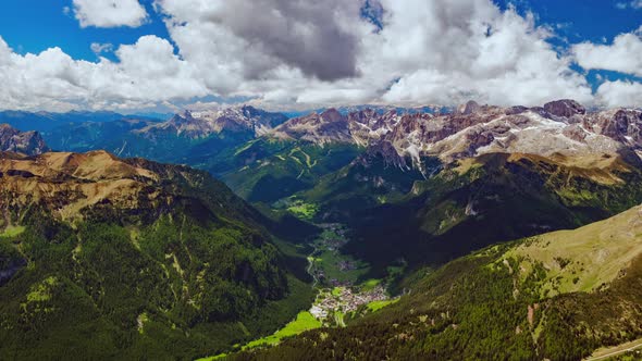 4K Aerial timelapse of of moving clouds over Campitello di Fassa, a comune in Trentino, Italy alt