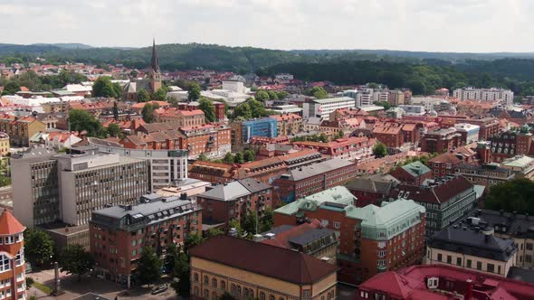 Downtown buildings of Swedish town Borås, aerial fly forward view alt