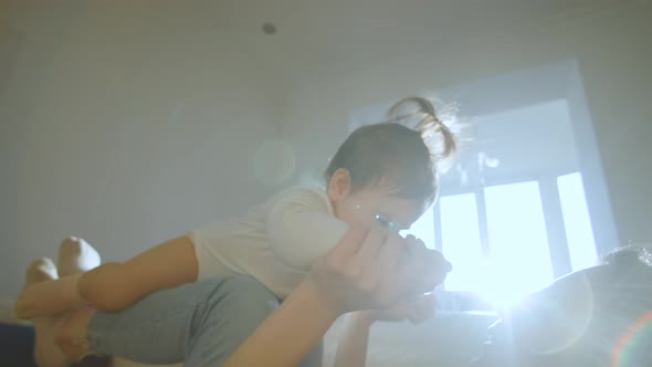 Happy Family Loving Young Mum Playing Cute Funny Baby Daughter Sit on Couch at Home alt