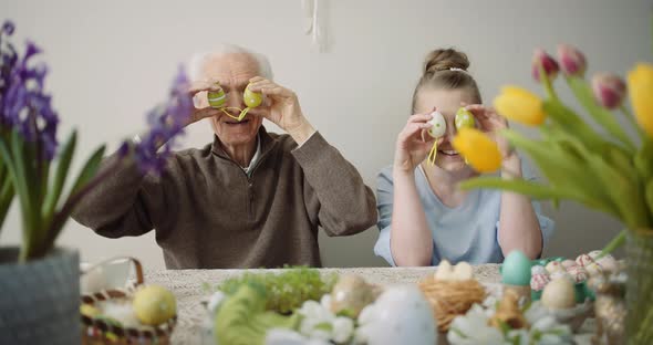 Happy Easter - Cheerful Grandfather and Granddaughter Play with Easter Eggs on Easter alt