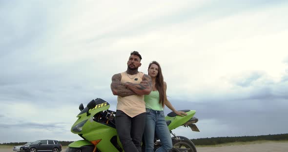 Stylish Couple on Motorbike on Beach