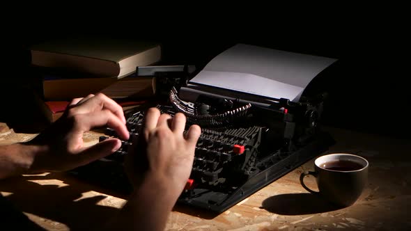 Man Typing a Typewriter at Night Creates a New Novel alt