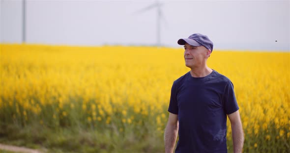 Agriculture - Farmer or Agronomist Walking on Agricultural Field alt