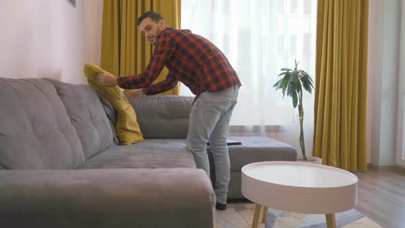 Freelancer Prepares His Workplace on a Comfortable Sofa at Home alt