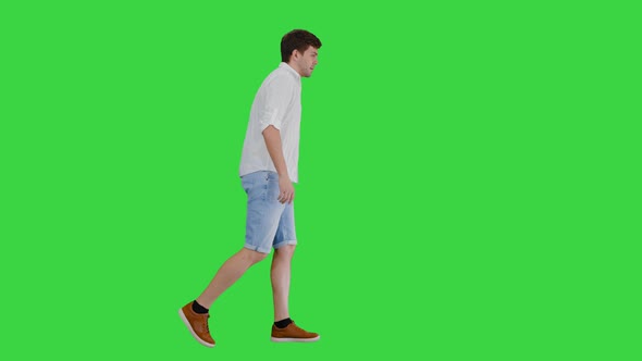 Exhausted Young Man Walking Touching His Shirt While Suffering From Summer Heat Green Screen Chroma alt