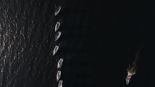 Sailing Yachts Lined Up in the Sea During a Sailing Regatta and Cast Shadows alt