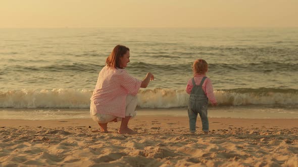 Mom with a Small Child on the Beach