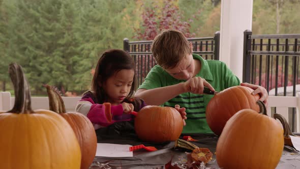 Kids carving pumpkins for Halloween