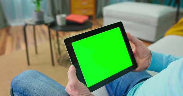 Close Up of Digital Tablet with Blank Green Mock Up Screen Display Hold By Old alt