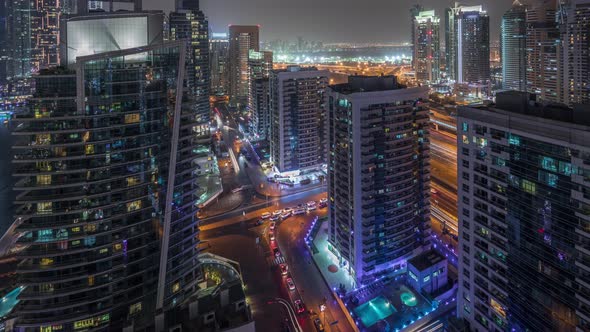 View of Various Skyscrapers and Towers in Dubai Marina From Above Aerial Night Timelapse alt