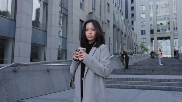 Camera Slowly Approaching to Young Adult Asian Woman in the City alt